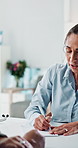 Doctor, woman and writing prescription for patient, healthcare and symptoms with treatment plan. Medical professional, script and note with mature person for help, referral letter and smile in clinic
