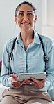 Doctor, woman and face with tablet for healthcare, medical support or schedule for treatment. Digital tech, mature professional and portrait in clinic for cardiology, wellness and smile for about us