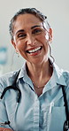 Doctor, woman and face with arms crossed in office for medical support, check up or treatment. Healthcare, mature professional and portrait in clinic for cardiology, wellness and smile for about us
