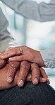 Elderly, people and holding hands with empathy for support, love or understanding in hospital. Closeup, senior or touch with comfort or sympathy for medical condition, bad news or diagnosis in clinic
