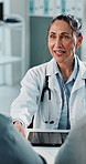 Handshake, consultation and doctor with couple in hospital for discussion, greeting or treatment plan. Happy, diagnosis and medical worker shaking hands with people for support at checkup in clinic.
