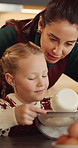 Happy mom, baking or teaching with child in kitchen for flour recipe or ingredients together in home. Mother, daughter or showing junior baker with bowl for christmas cookies or dessert in house