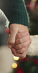 Christmas, mom or daughter in house with holding hands, childcare or bonding together in xmas celebration. Bokeh, woman or child with care, family connection or healthy relationship in festive season