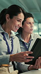 Tablet, discussion and team of business women in office with research for AI development project. Digital technology, meeting and female engineers with planning for computing assignment in workplace.