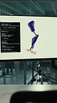 Computer screen, programming and code for robotics with prosthetic leg, interior and ui at lab. Monitor, software and pc with futuristic tech in empty room, artificial limb or innovation for mobility