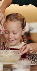 Happy child, mom and whisk with flour in kitchen for baking recipe or ingredients together in home. Mother, daughter and teaching junior baker with bowl for christmas cookies or dessert in house