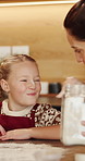 Happy child, mom and nose with flour in kitchen for fun baking or bonding together in home. Mother, daughter and playing with junior baker or smile for prep, christmas cookies or dessert in house