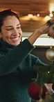 Smile, woman and ball with tree for Christmas decoration, celebration and holiday tradition. Mature person, ornament and bauble for festive season, xmas event and prepare for new year party at house