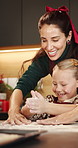 Christmas, mom and girl with flour in kitchen for teaching, festive season or baking help for bonding. Smile, clap or woman with playful child for holiday snack preparation, learn or cooking in home