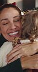 Christmas, mother and daughter with hug in house, happiness and family bonding for festive season cheer. Embrace, love and woman with child for holiday celebration, support and security in apartment