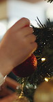 Hands, child and ball with bauble for Christmas decoration, celebration and holiday tradition. Closeup, family and ornament with sparkle for festive season, xmas event and aesthetic for party in home