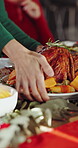 Family, hands and roast chicken in home with Christmas dinner, traditional meal and cuisine for feast. People, meat dish and food in dining room for festive season, social gathering and xmas holiday.
