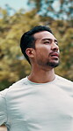 Fitness, tired and man outdoor in nature for fresh air, recovery and wellness with environment. Exercise, workout and male runner in park for rest, breath and athlete training or thinking