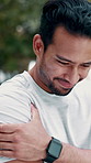 Fitness, man and tired outdoor with shoulder pain, fibromyalgia symptoms or hurt from intense workout. Active, person and exhausted with fatigue from difficult exercise, sports injury and discomfort.
