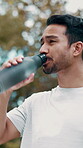 Fitness, thinking and asian man drinking water outdoor in nature for thirst, break and wellness. Exercise, workout and male runner in park for rest, hydration and athlete training or healthy drink