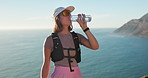 Hiker, sunglasses and woman drink water for break, outdoor holiday adventure and liquid for hydration. Ocean, thirsty or person with bottle on trekking expedition, space or shades for travel vacation