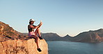 Woman, hiking and phone for photo on mountain top with ocean view, space or relax in summer. Girl, smartphone and post on break, rocks or profile picture for trekking, app and social media on cliff