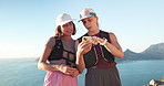 Hiking, phone and talking with women at ocean together for location, map search or planning. App, communication and directions with friends outdoor in nature for adventure hike, hobby or travel