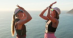 Friends, hiking and high five by sea with hug, sunglasses outdoor and fitness achievement together. Hiker, women and celebration by ocean with shades, bonding and embrace for workout accomplishment.