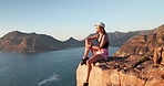 Woman, hiking and thinking with rest on mountain with ocean view, space and relax on summit. Girl, outdoor and break on peak, rocks and perspective for trekking, adventure or sunglasses in summer