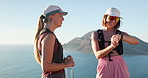 Outdoor, friends and women with smart watch for hiking, check step counter and journey time discussion. Ocean, trekking adventure and people with tech for distance tracking, talk and smile on holiday