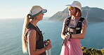 Hiking, friends and women with smart watch on mountain, check step counter and journey time discussion. Ocean, trekking adventure and people with tech for distance tracking, talk and smile on holiday