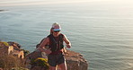 Fitness, runner and woman with sunglasses on mountain, cliff trail and workout for endurance training. Sunset, active and athlete with jog for cardio exercise, shades and outdoor challenge by ocean