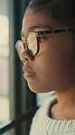 Glasses, thinking and sad with child at window in home for memory, abandoned and foster trauma. Grief, reflection and separation anxiety with girl in apartment for worry, fear and mindset crisis