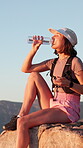 Mountain, water and woman on hiking break to relax, rest and cliff view with thirst. Female person, fitness and space outdoor with fresh drink, hydration and bottle for exercise and wellness