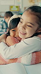 School, happy and children hug in classroom for education, learning and happy together in lesson. Academy, friends and girls with embrace and bonding for knowledge, child development and education
