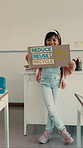 School, recycling and child in classroom with poster for conservation, climate change and sustainability. Happy, academy and girl with sign for earth day, education and oral assessment for lesson