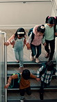 School, stairs and above of children in hallway ready for education, class and learning together. Academy, happy and students walking on steps on campus for knowledge, youth development and lesson