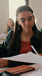Education, test and results with students in classroom for problem solving, assessment and learning. Studying, teenager and knowledge with people in high school for academy, scholarship and course