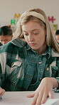 Writing, education and test with student in classroom for learning, assessment and scholarship advice. Course, knowledge and academy with girl in high school for teenager, problem solving and answer