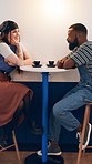 Happy couple, talk and date at coffee shop with drinks, bonding and relax with connection for love. Man, woman and interracial relationship with espresso, conversation and smile with chat at cafe