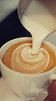 Hands, barista and milk in coffee for art with heart shape, creative beverage or preparation process. Person, drink and pour foam in latte mug for cappuccino, dairy cream and morning brew in cafe