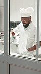 Black man, pastry chef and baking with dough in kitchen for bread, dessert or production. Male person, culinary artist or baker kneading with flour for preparation, catering or hospitality in factory