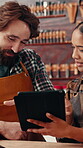 Leather workshop, people and tablet with discussion, planning and tools for unique textile product. Ecommerce, online sales and man with woman in small business for tannery, schedule or communication