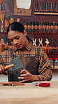 Leather workshop, woman and tools with craft, manufacturing and unique textile product. Hammer, fabric and artisan with tannery, small business and service with repair process and suede texture