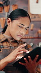 Leather workshop, woman and scroll with tablet, tools and manufacturing of unique textile product. Thinking, ecommerce and artisan with tannery, small business and service for repair or online order