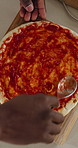 Hands, person and pizza with sauce in home for meal prep, vegan ingredients and Italian recipe. Above, chef and cooking pastry with tomato spread, healthy food and culinary skills for homemade lunch