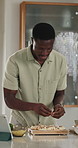 Black man, cooking and pizza with tablet in home for online video, meal prep and Italian recipe. Person, digital or tutorial with mushroom toppings, healthy food and culinary skills for lunch cuisine