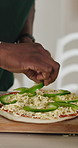 Hands, person and vegetables on pizza at house for meal prep, ingredients and Italian recipe. Chef, cooking and organic toppings for pastry flavor, healthy food and culinary skills for homemade lunch