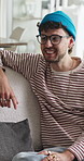 Home, smile and man on sofa, conversation and bonding together in living room. Apartment, relax and happy people on couch, discussion and gossip for funny story, weekend break and communication