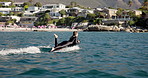 Sea, water sports and woman on electric surfboard for active, workout or fitness on vacation. Travel, adventure and female person on efoil by ocean for exercise, training or surfing on holiday.
