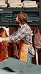 Man, textile factory and ladder with shelf for fabric, leather or manufacturing with thinking. Small business, storage and warehouse manager for stock, fashion or cloth for material quality assurance