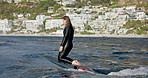 Sports, sea and woman on electric surfboard for active, workout or fitness on vacation. Travel, adventure and female person on efoil by sea for exercise, training or surfing challenge on holiday.