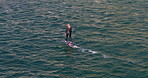 Ocean, active and woman on electric surfboard for fitness, workout or water sports on vacation. Travel, adventure and female person on efoil by sea for exercise, training or surfing on holiday.