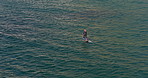 Sea, fitness and woman on electric surfboard for active, workout or water sports on vacation. Travel, adventure and female person on efoil by ocean for exercise, training or surfing on holiday.