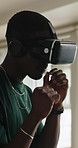 Black man, fighting or boxing with VR headset in home for playing, virtual reality or gaming. Male person, fighter or simulation boxer throwing punches with goggles for futuristic video game in house